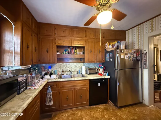 a kitchen with a refrigerator and a sink