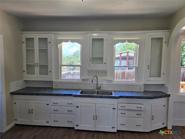 a kitchen with sink and cabinets