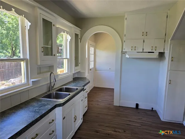 a view of an entryway with wooden floor and windows