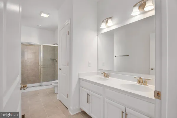 a bathroom with a double vanity sink and a mirror