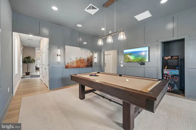 a room with pool table and a chandelier