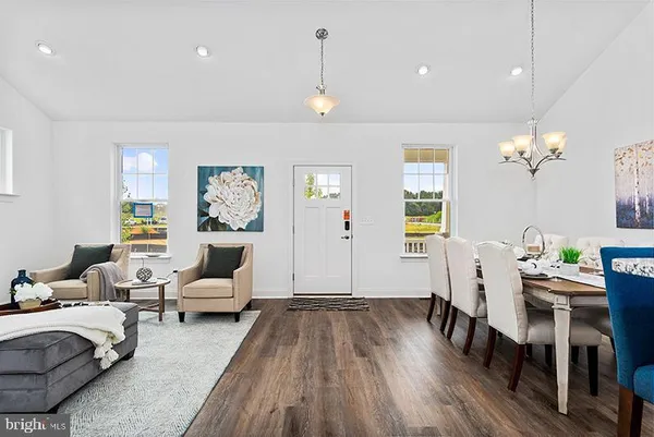 a living room with furniture dining table and wooden floor