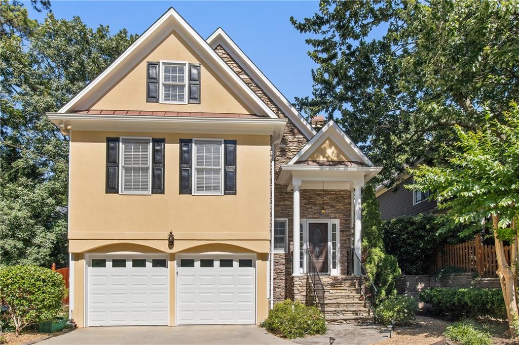 a front view of a house with a tree