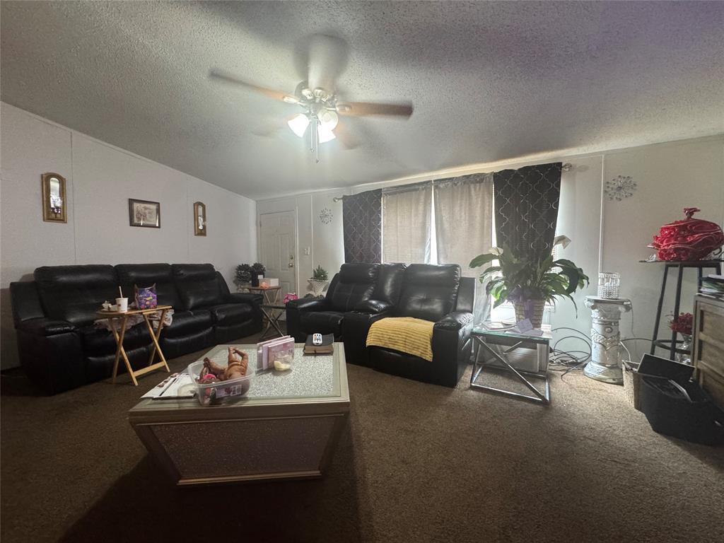 1614 Cole Road Bellmead, TX 76705 - Photo 8 of 21 Living area featuring wall-to-wall carpeting and a ceiling fan with light fixture