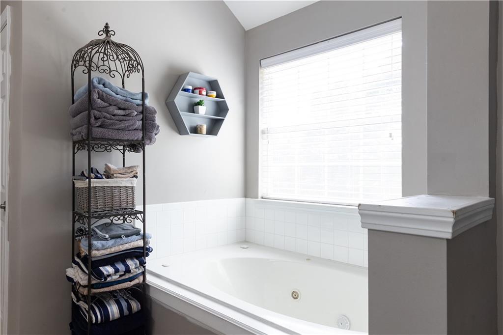 417 Farmwood Way Canton, GA 30115 - Photo 21 of 33 a bathroom with a bathtub a sink and a window