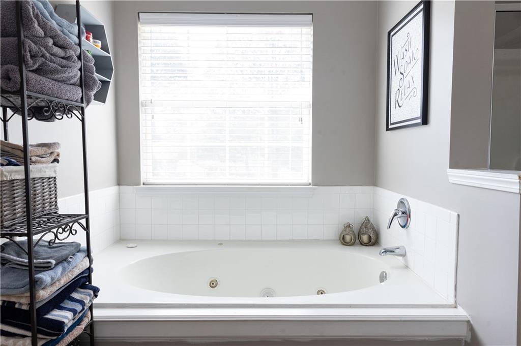 417 Farmwood Way Canton, GA 30115 - Photo 25 of 33 a bathroom with a bathtub and next to a window