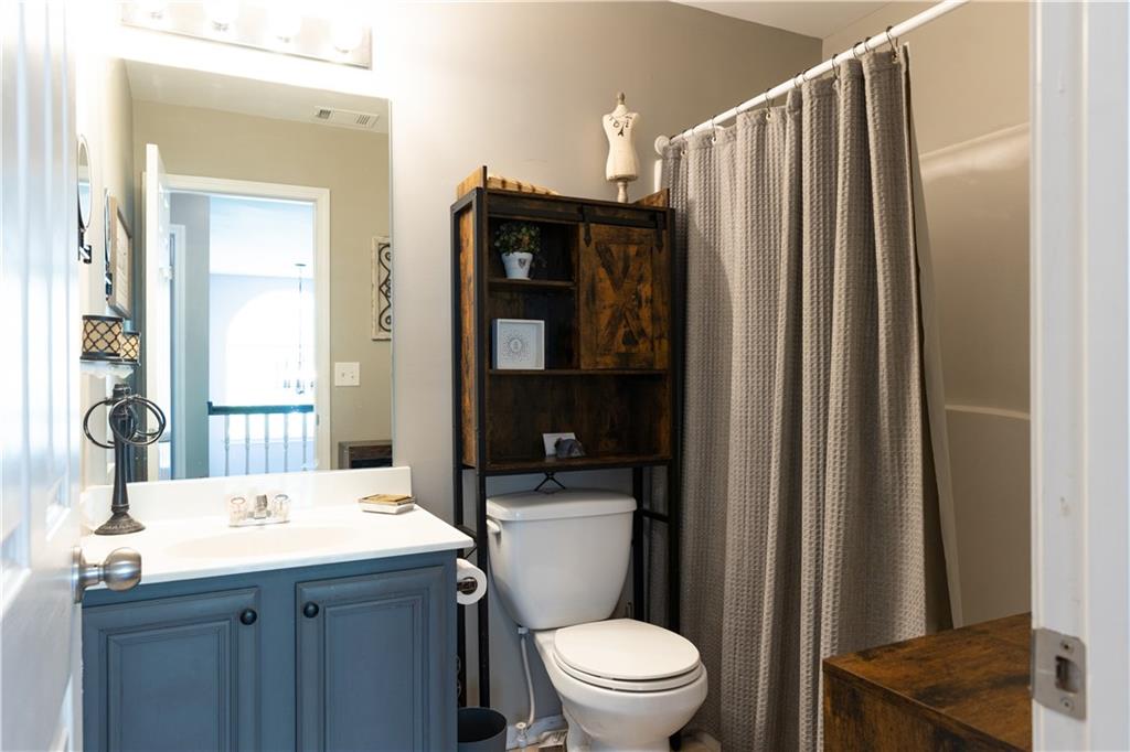 417 Farmwood Way Canton, GA 30115 - Photo 28 of 33 a bathroom with a sink a toilet and shower