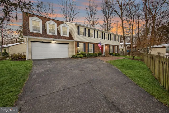 a view of a white building among the street with palm trees