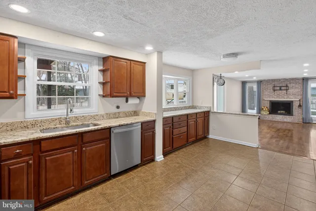 a large kitchen with granite countertop a stove and a sink