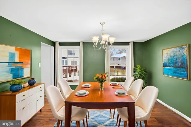 a view of a dining room with furniture a livingroom and chandelier