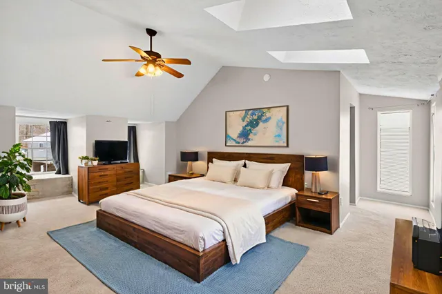 a bedroom with a bed and ceiling fan