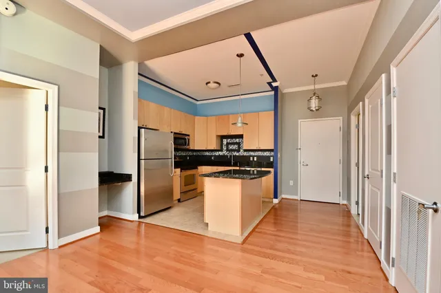 a kitchen with stainless steel appliances granite countertop a refrigerator and a sink