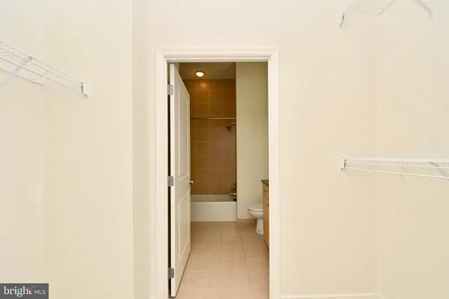 a bathroom with a granite countertop sink mirror toilet and bathtub