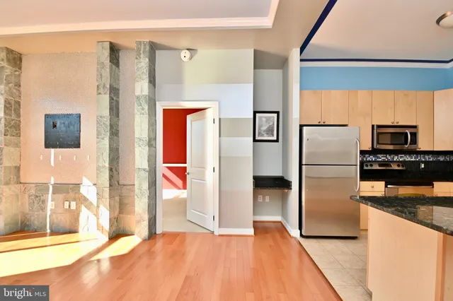 a kitchen with stainless steel appliances a refrigerator and a stove top oven