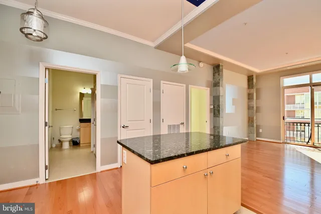 a bathroom with a granite countertop sink and shower