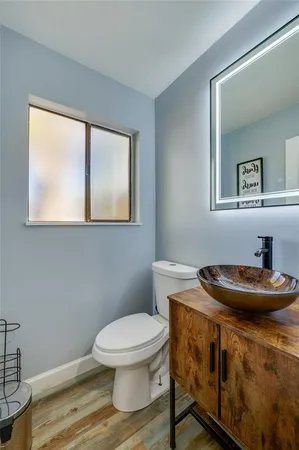 a bathroom with a toilet a sink and mirror