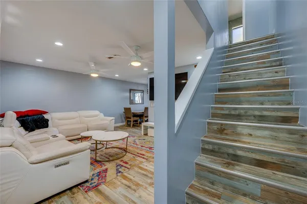 a living room with furniture and a stair