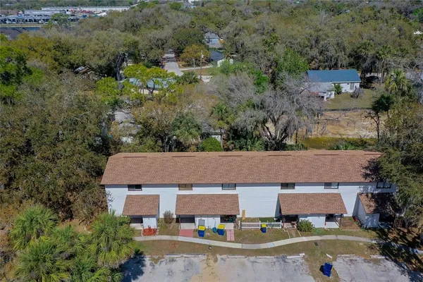 an aerial view of a house with yard