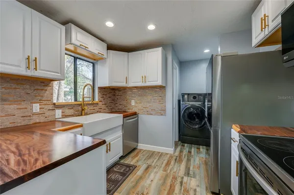 a kitchen with a refrigerator and a sink