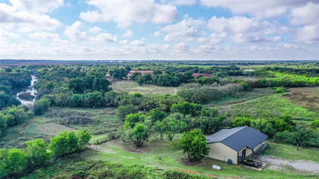 a living room with furniture a flat screen tv and a large window