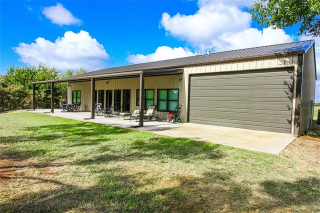 a kitchen with stainless steel appliances a stove a sink dishwasher a refrigerator and a oven with wooden floor