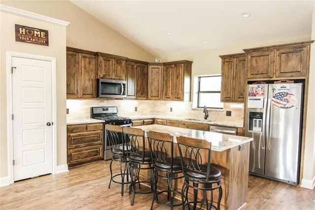 a spacious bedroom with a bed and a chandelier