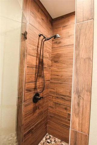 a view of a storage and utility room with washer and dryer