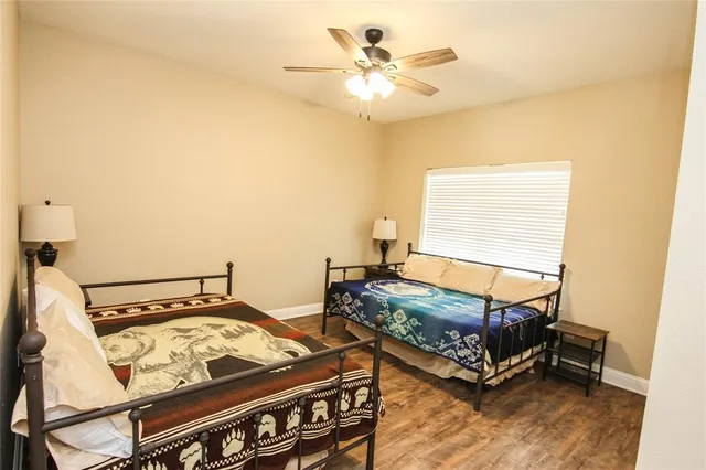 a view of a patio with table and chairs under an umbrella