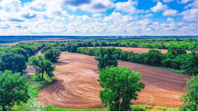 a backyard view with flower garden and wooden fence