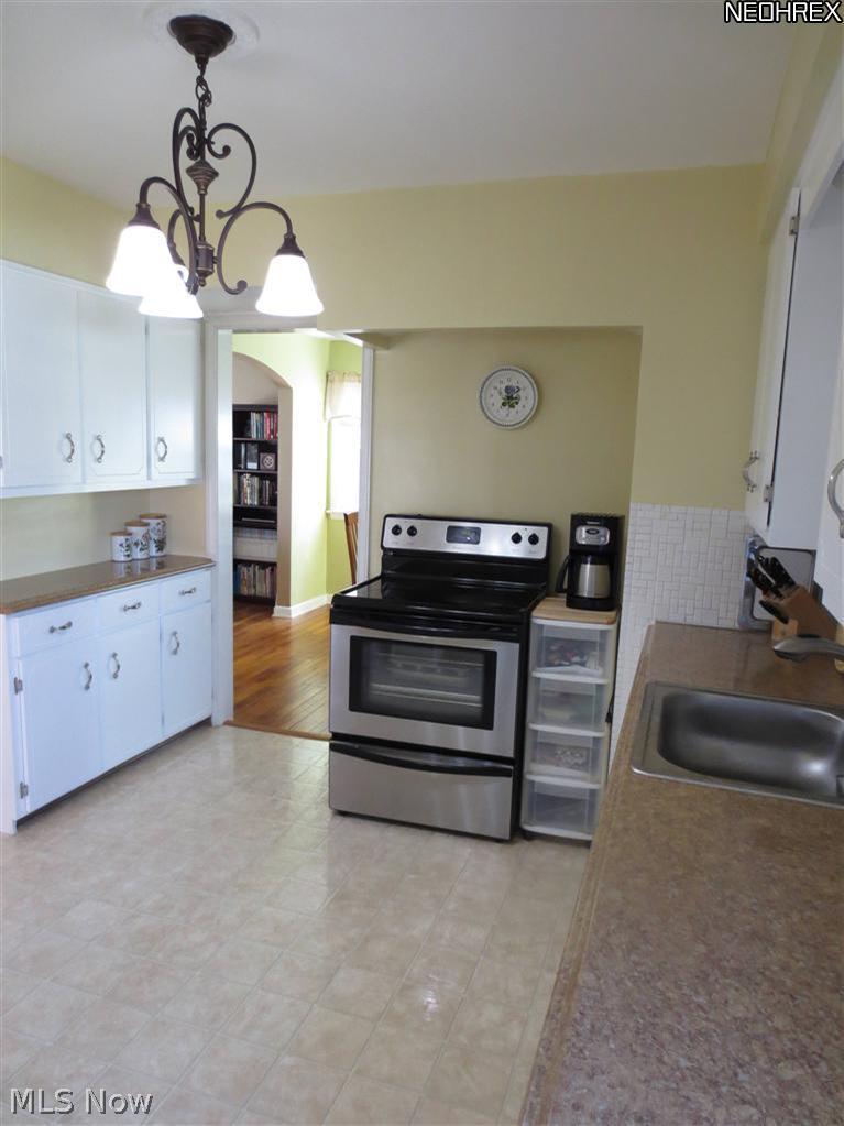 3817 Faversham Road Cleveland, OH 44118 - Photo 4 of 20 Spacious Eat-in Kitchen with White Cabinetry, Newer Counter Tops, and Newer Appliances