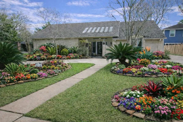 a view of a flowers in a yard with swimming pool