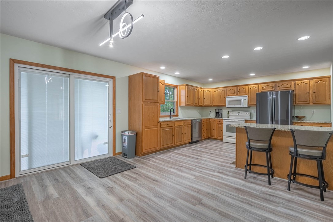 2645 Vance Road St. Paris, OH 43072 - Photo 8 of 35 This spacious kitchen offers a practical layout with ample cabinetry, an island, and convenient outdoor access.