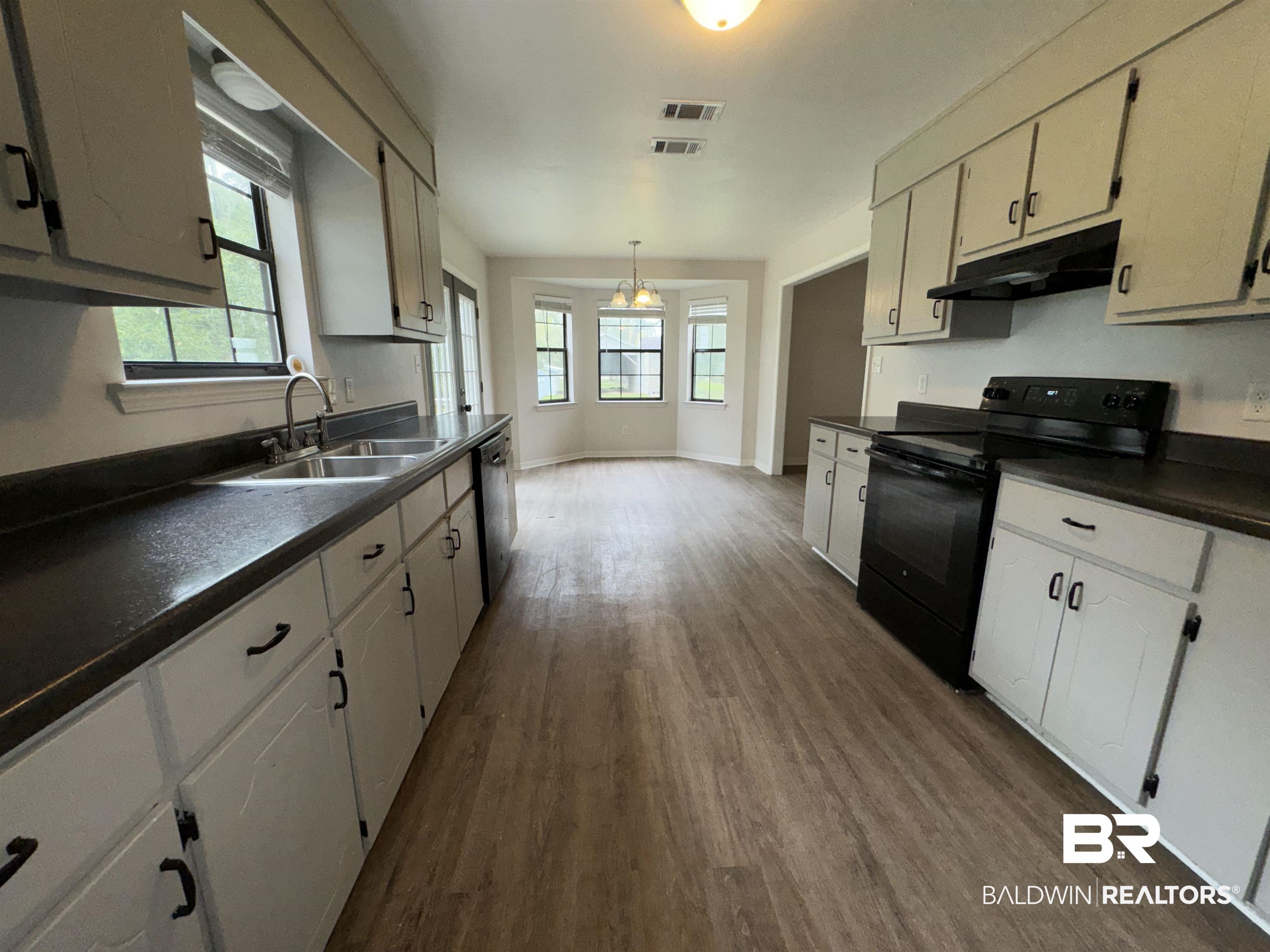 70 Plum Street Uriah, AL 36480 - Photo 7 of 36 Kitchen with white cabinets, dishwasher, black electric range oven, dark hardwood / wood-style floors, and sink