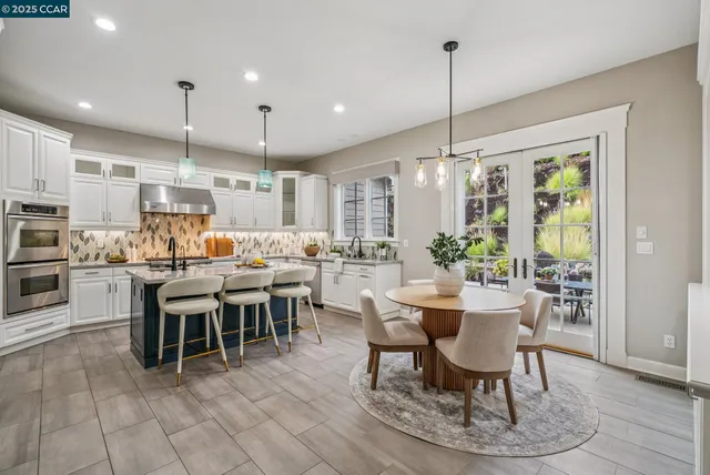 a dining table chairs and a view of kitchen