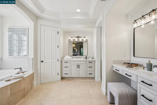 a bathroom with a sink vanity and mirror