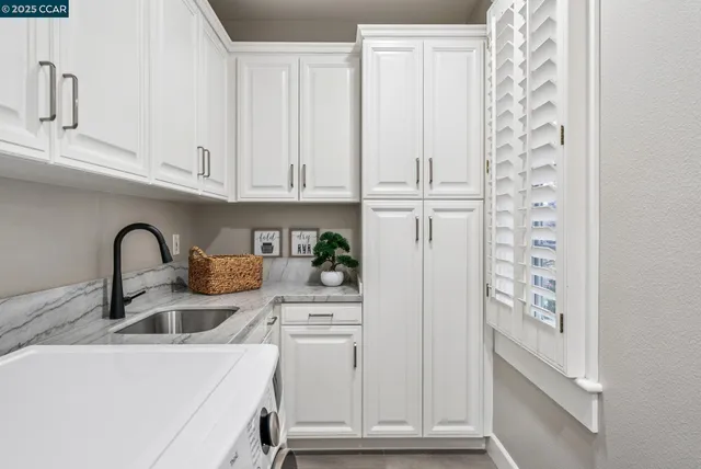 a kitchen with appliances cabinets and a sink