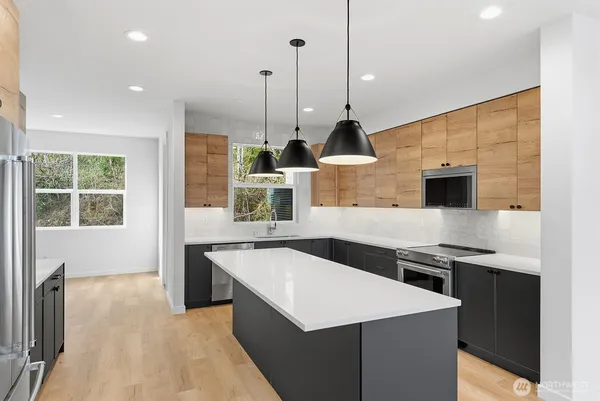 a kitchen with stainless steel appliances a sink a stove and a refrigerator