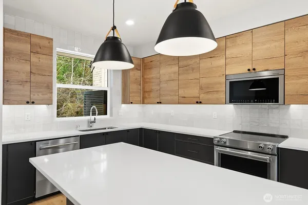 a kitchen with a sink a stove and a microwave