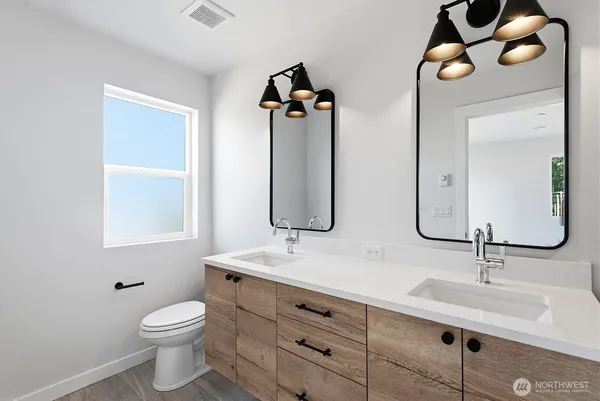 a bathroom with 2 sink and a mirror