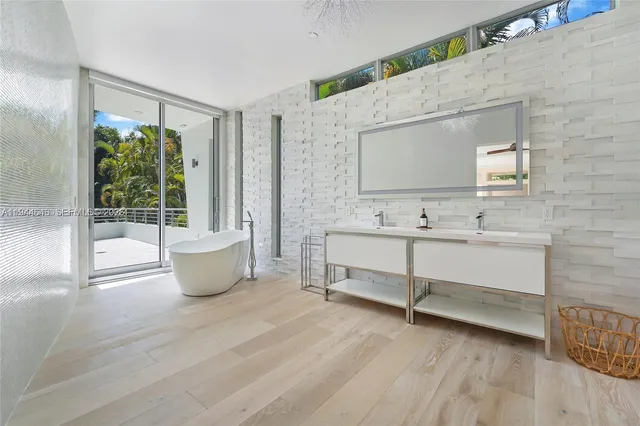a view of a bathroom with a tub sink and mirror