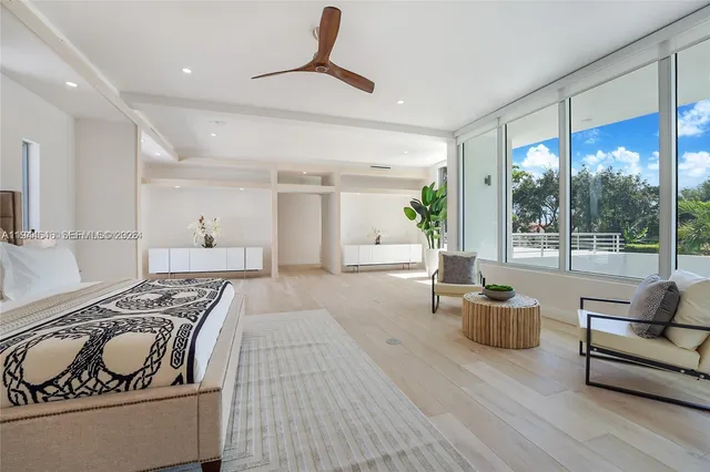 a living room with furniture and a floor to ceiling window