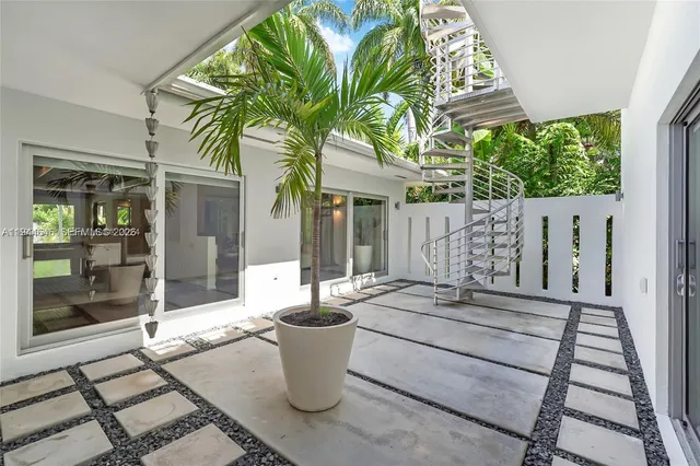 a view of a patio with table and chairs and potted plants