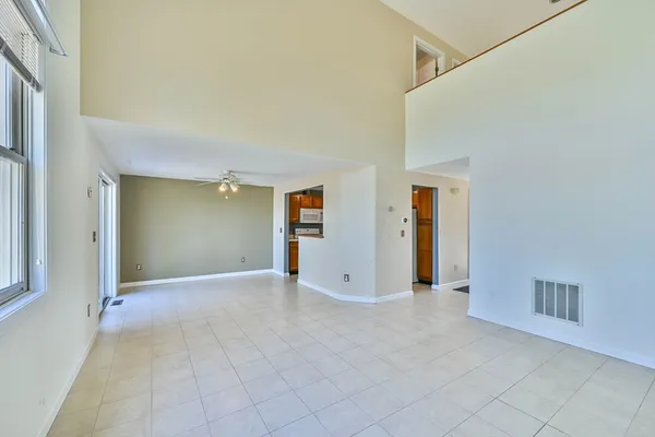 an empty room with windows and closet