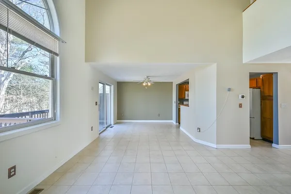 an empty room with a bathroom and a shower