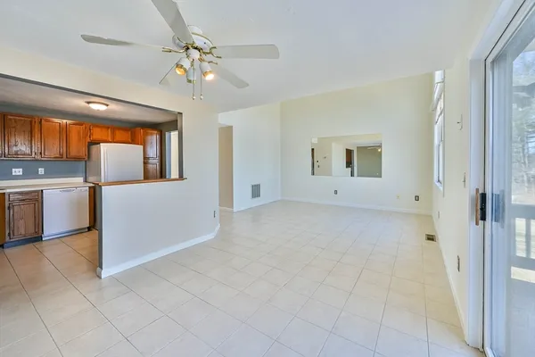 an empty room with a empty space and a ceiling fan