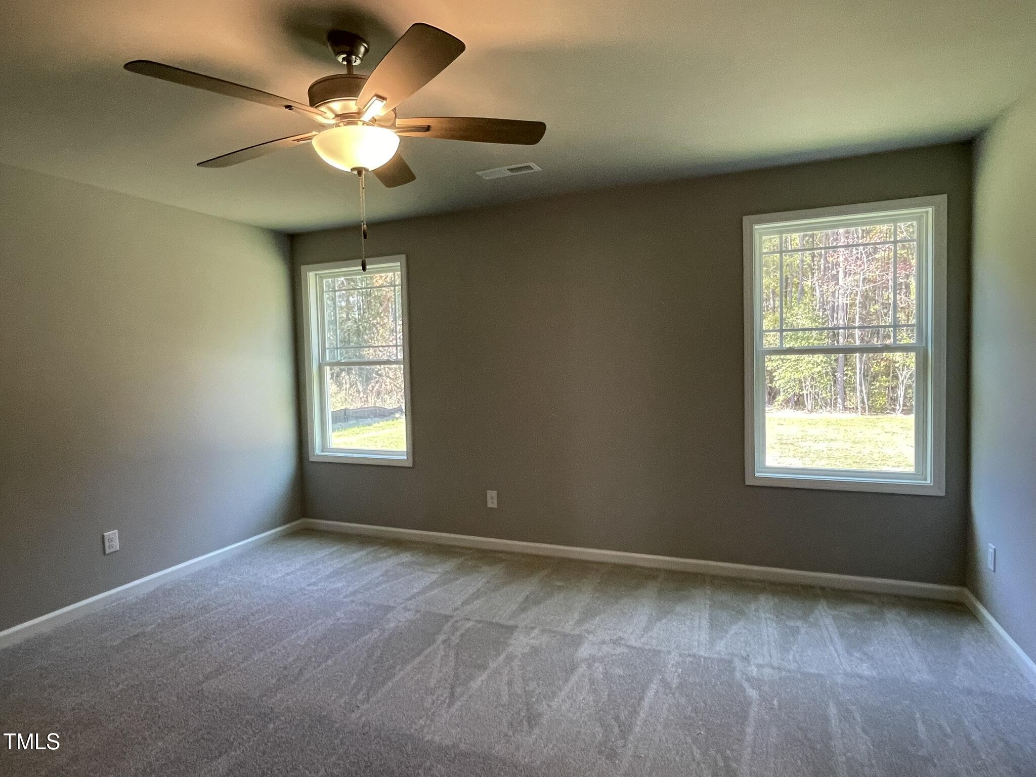 79 Tulipfield Way Benson, NC 27504 - Photo 11 of 19 a view of an empty room with a window