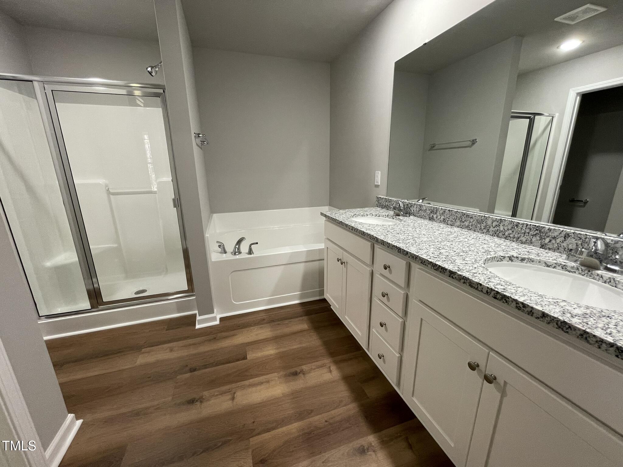 79 Tulipfield Way Benson, NC 27504 - Photo 14 of 19 a bathroom with a granite countertop sink mirror vanity and bathtub