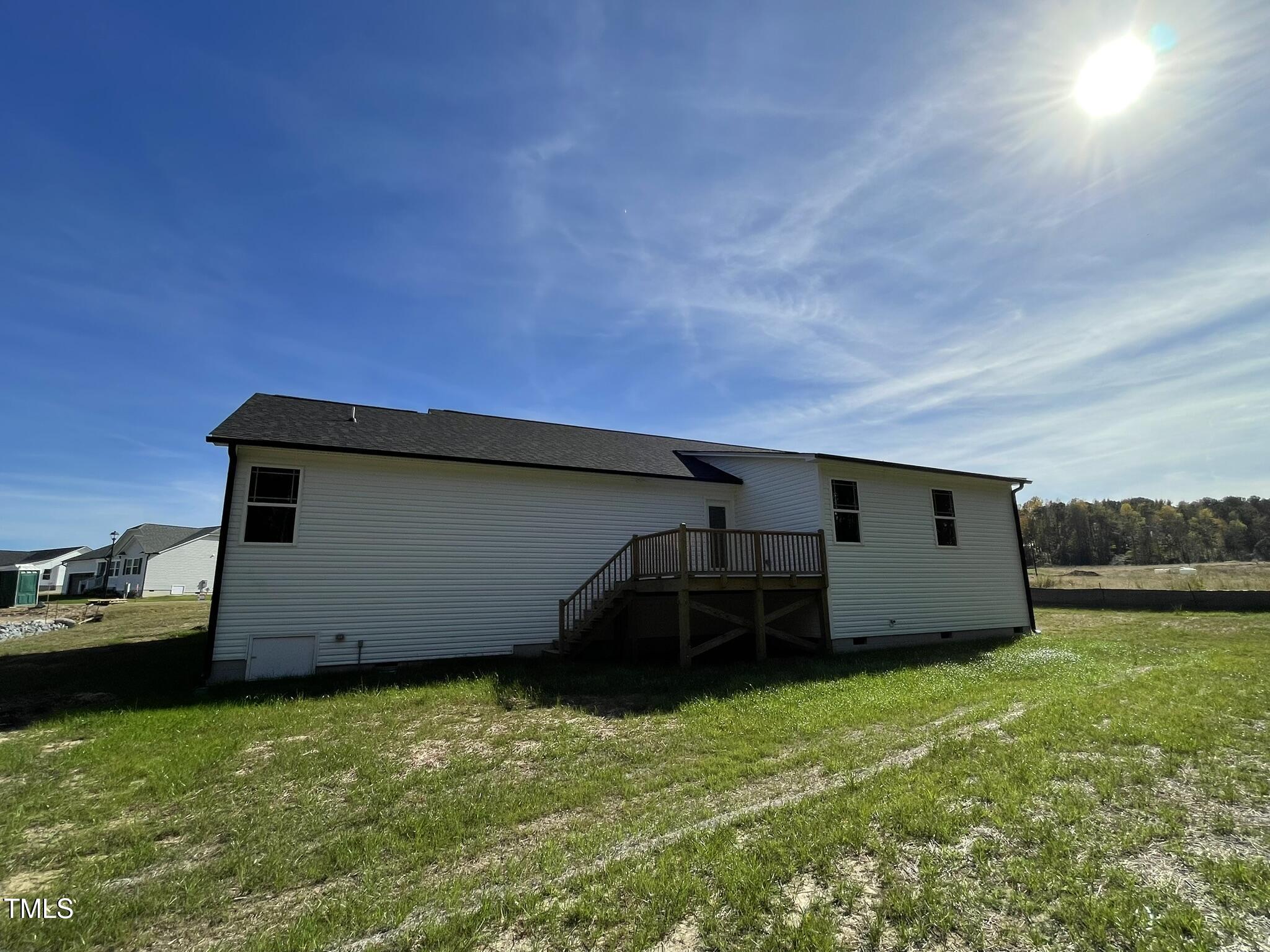 79 Tulipfield Way Benson, NC 27504 - Photo 18 of 19 a house view with a garden space