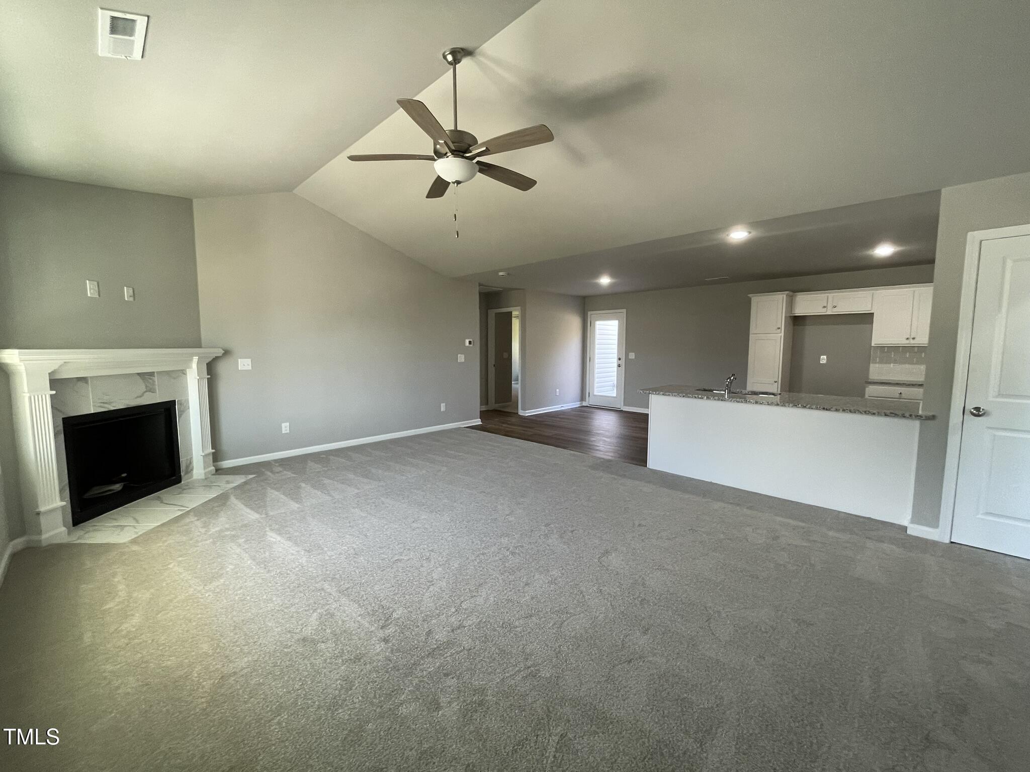 79 Tulipfield Way Benson, NC 27504 - Photo 2 of 19 a view of an empty room with a fireplace