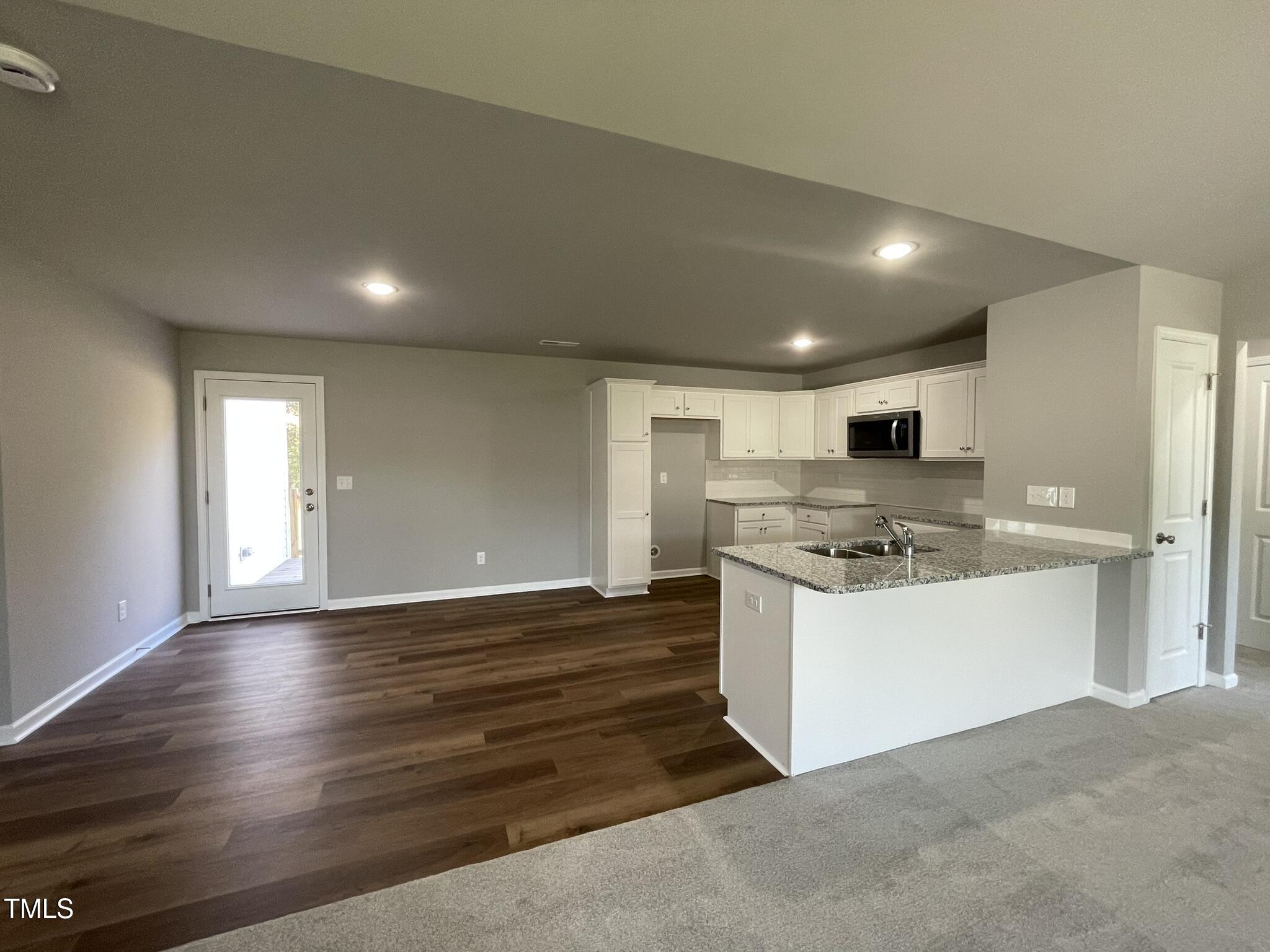 79 Tulipfield Way Benson, NC 27504 - Photo 3 of 19 a kitchen with stainless steel appliances a sink a stove a refrigerator and cabinets